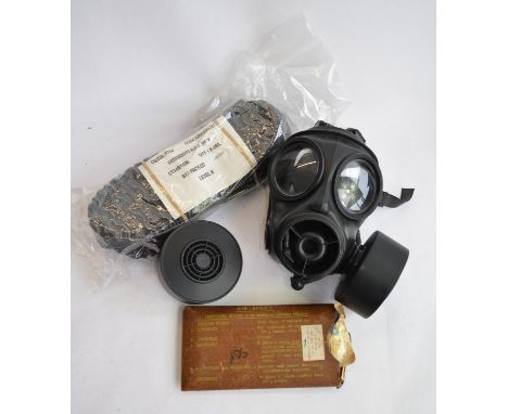 An ex-British Army Avon 1990 twin port gas respirator with 2 cartridges (appears unused), a set of NBC MkV overboots dated 19