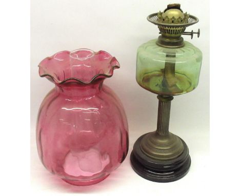 Late Victorian paraffin oil lamp with green tinted reservoir, fluted column on circular moulded black glass base, H42cm; oil 