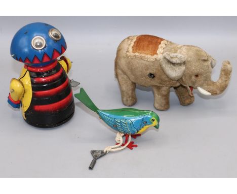 Clockwork toys - a plush elephant, H9cm; a Marx tinplate alien, H13.5cm; and a similar Minic bird, H7.5cm (3) 