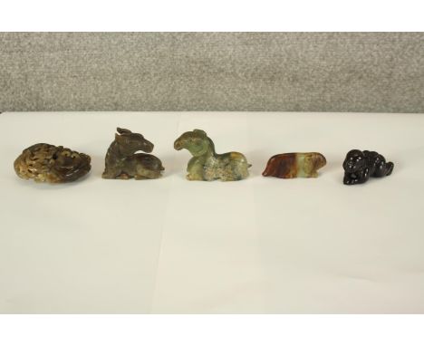 A collection of five Chinese jade, soapstone and hardstone carvings, including a horse, a ram, a crawling baby and a rodent. 