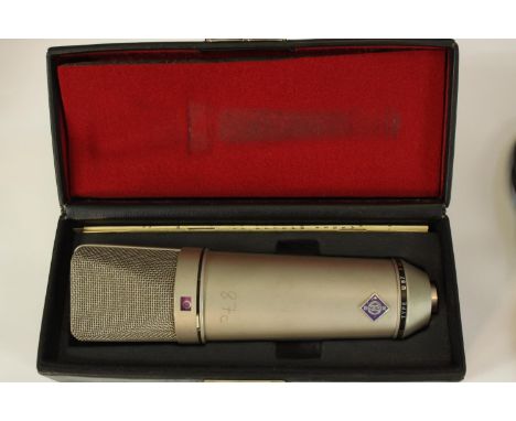 Neumann U87 microphone and stand. Circa 1975 but possibly earlier. Complete with its padded box, lead and a stand. The U87 is