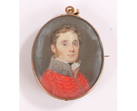 George III miniature portrait, of an officer in a red military tunic, the reverse with initials set within the hair, 41mm dia