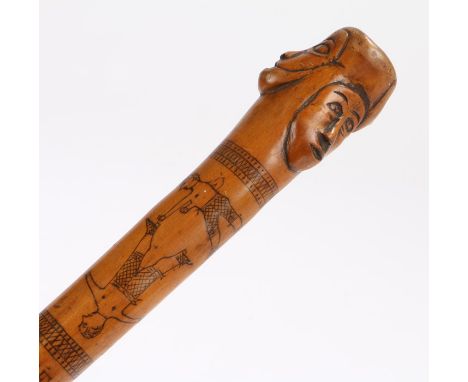 Late 19th Century Folk Art walking stick, the stick carved with raised faces, an etched boxing scene a clock and hunting and 