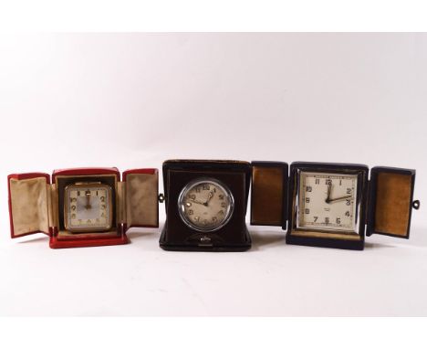 A Smiths alarm clock with chrome surround, 7.5cm square, cased, a French alarm clock in red leather case, and a Swiss made tr