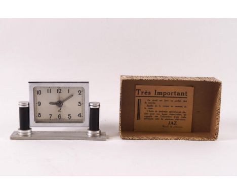 A French Art Deco alarm clock by Jaz, with chrome surround, steel and bakelite base, 9cm high, in original box with instructi