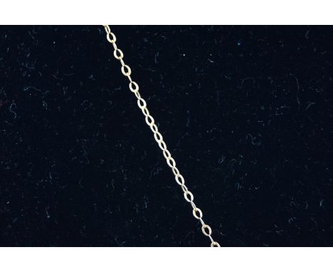 An Edwardian rose gold and ruby pendant in the form of a horseshoe entwined with flowers and leaves, stamped '9ct', on a rose