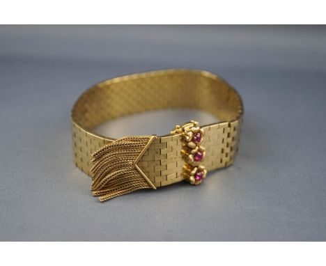 A 1960/70's ruby and brick-link bracelet, adjustable in length with a pointed and tassel terminal and a small round mixed-cut