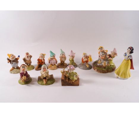 A collection of twelve Royal Doulton Snow White and the Seven Dwarves figures comprising: Snow White, Sneezy, Grumpy, Dopey, 