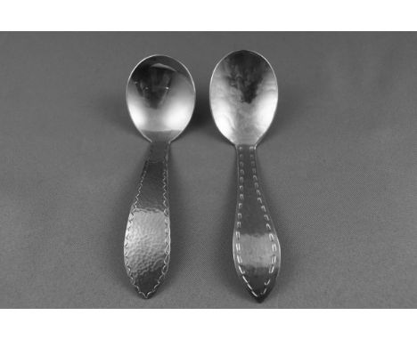 A Keswick School of Industrial Arts (KSIA) staybrite caddy spoon with a hammered bowl and a pointed handle with a decorative 