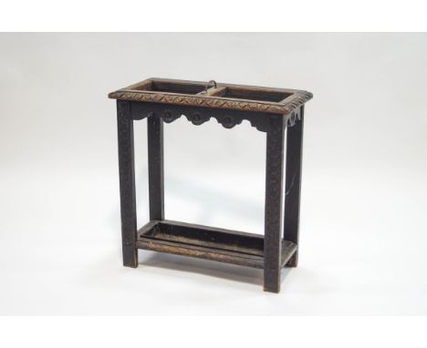 A Victorian carved oak stick stand, the central divider with brass handle, 61cm high x 60cm wide x 27cm deep