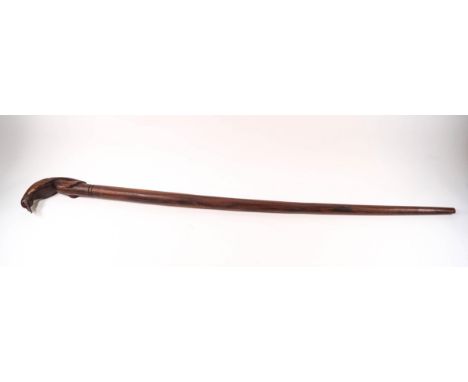 A wooden walking stick, the handle being a carved bird