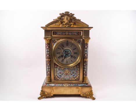 A French clock with Champleve enamel decoration, eight day French movement striking the half and hours on a gong, 38cm high, 