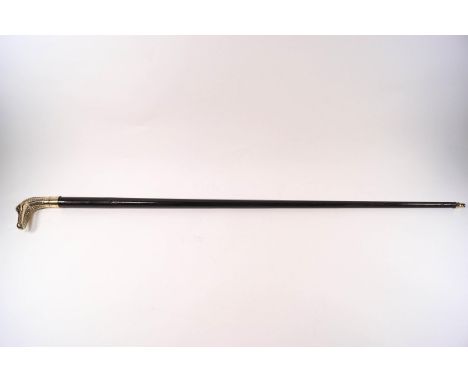 An ebonised walking stick with brass crocodile handle