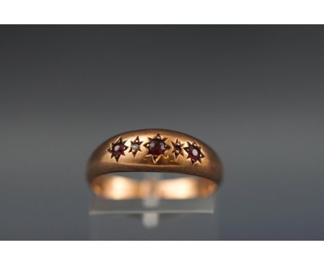 An Edwardian 9ct rose gold and small ruby and diamond gypsy ring, Birmingham 1905, size O+, 1.3g gross.