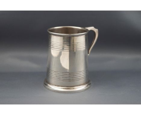 A silver straight-sided christening mug with two engraved bands, uninscribed, Sheffield 1934 by William Hutton & Sons Ltd, 9.