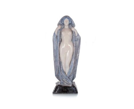 MARCEL GUILLARD FOR EDITIONS ETLING OF PARIS, CERAMIC NUDE OF A LADY, CIRCA 1920 modelled standing with cloak, over a tapered