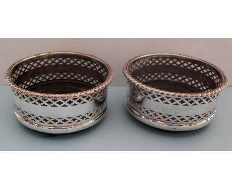 A pair of pierced silver plated wine bottle coasters, 8.5 cm diameter