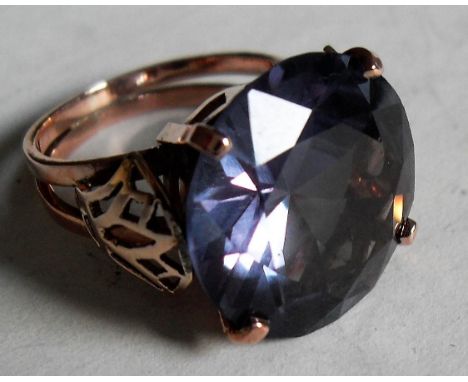 An alexandrite round-cut ring set in 9K rose gold with matching earrings, stamped 9K, size K, gross weight 12.39g