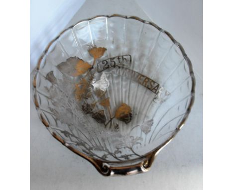 A silver overlaid-on-glass scalloped dish with floral design commemorating '25th Anniversary' and a circular sectioned dish w
