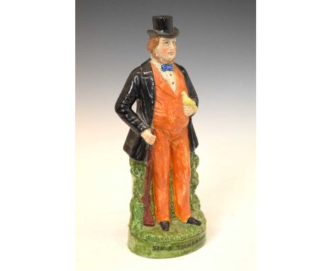 19th Century polychrome Staffordshire figure of Arthur Orton, the Tichborne Claimant, modelled standing with a gun in one han