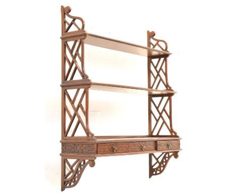 Reproduction Chinese Chippendale style mahogany waterfall wall shelf, pierced fretwork sides supporting three graduated shelv