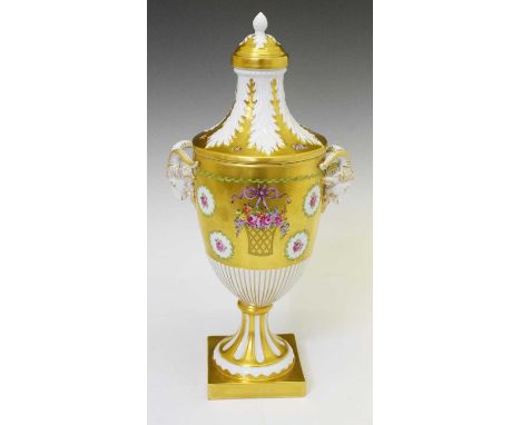 Dresden urn and cover, decorated with a gilt ground, floral baskets and goat head mask handles, marks to base, impressed no. 