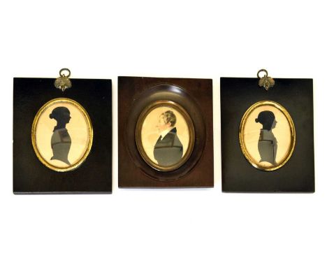 Early 19th Century oval framed portrait miniature on card of a gentleman, together with two silhouettes in ebonised frames (3