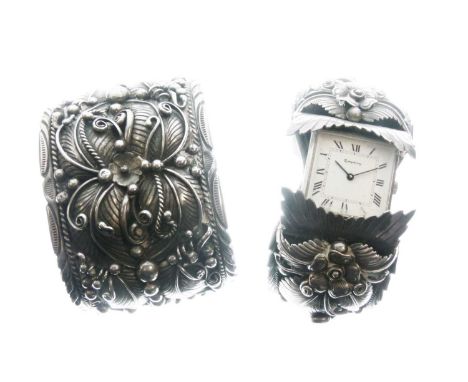 Navajo-style white metal cuff bangle with foliate and feather decoration, stamped 'MT Sterling', and a similar cuff bangle wi