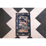 A Chinese Pao Tao rug with deer and cranes in a landscape, mid 20th C.