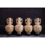 Four Chinese bone bottle vases with carved figurative design, 20th C.
