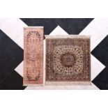 A Persian Qom (Qum/Ghom) silk rug and a Chinese silk Hereke rug with floral design, 20th C.