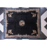 A large Chinese black ground 'dragons' carpet, wool on cotton, Beijing, 20th C.