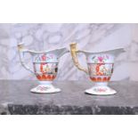 A pair of Chinese famille rose helmet-shaped 'Mandarin' jugs, Qianlong