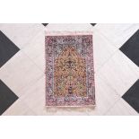 A Chinese silk Hereke carpet with gold threads and floral design, 20th C.