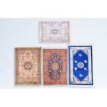 A Chinese woollen 'Beijing' rug with antiquities and three various Oriental rugs with floral design,