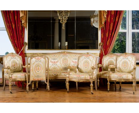 A French Louis XVI style silk upholstered gilt wooden six-piece salon suite comprising a canape, four armchairs and a firescr