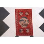 A Chinese Pao Tao rug with animated medallions, 20th C.