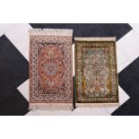 A Persian silk Kashmir rug and a silk Chinese rug with floral design, 20th C.