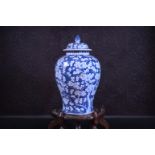 A Chinese blue and white prunus on cracked ice ground vase and cover, Kangxi mark, 19th C.