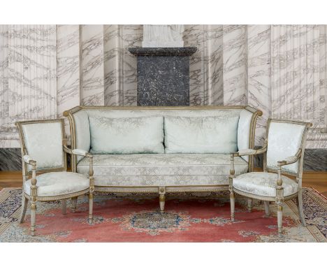 A French three-piece patinated and gilt wooden Louis XVI style salon set comprising a sofa and two armchairs with silk uphols