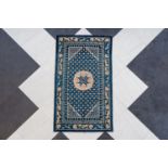 A Chinese Beijing carpet with floral design and stylized motifs, wool on cotton, 20th C.