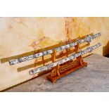 Two Japanese engraved bone katana on wooden stand, 20th C.
