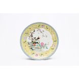 A Chinese famille rose yellow ground dish with birds among blossoming branches, Qianlong mark, 20th