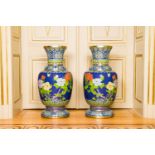 A pair of large Chinese cloisonne vases with butterflies among blossoming branches, 20th C.