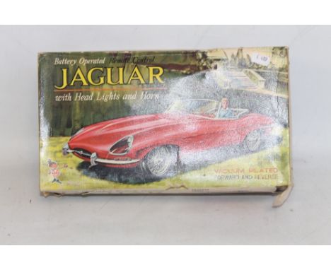 A BOXED MARX BATTERY OPERATED REMOTE CONTROL JAGUAR E-TYPE with head lights and horn  A/F