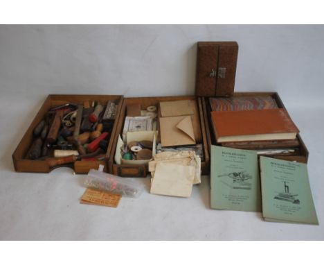 BOOK-BINDING TOOLS AND EQUIPMENT to include various knives and cutters, leather tools, gold leaf etc. contained in three wood