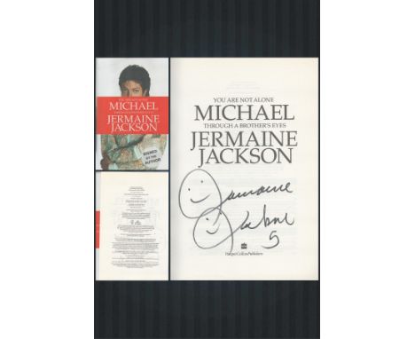 Jermaine Jackson signed hardback book titled You Are Not Alone Michael, Through A Brothers Eyes. This lovely book features a 