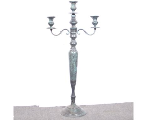 A large patinated brass three-light candlestand, vert-de-gris patination, height 98cm, width 46cm.