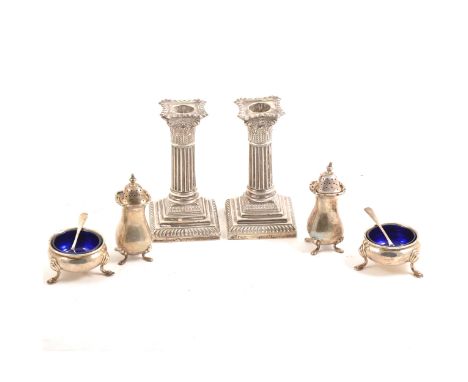 A pair of silver dwarf candlesticks by James Chesterman &amp; Co, Sheffield 1895, weighted, 14cm, a pair of silver salts by H