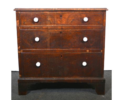 A George III walnut chest of drawers, of small proportions, rectangular top with rounded corners, moulded edge, broad cross-b